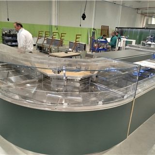 Curved serve-over counter being assembled on the factory floor